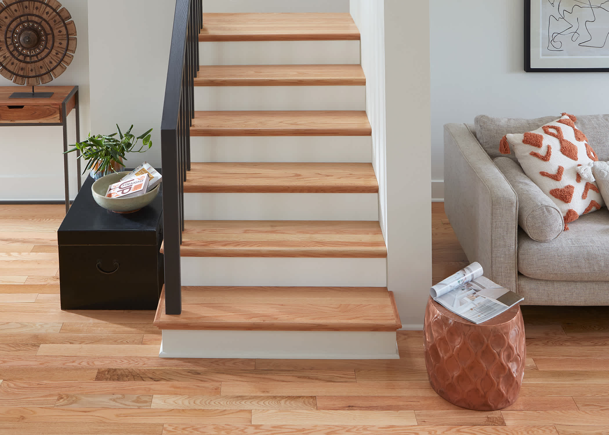 red oak stair treads and white stair risers leading to basement family room with red oak flooring