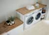 american cherry butcher block in laundry room on top of white washer and dryer plus storage cabinet
