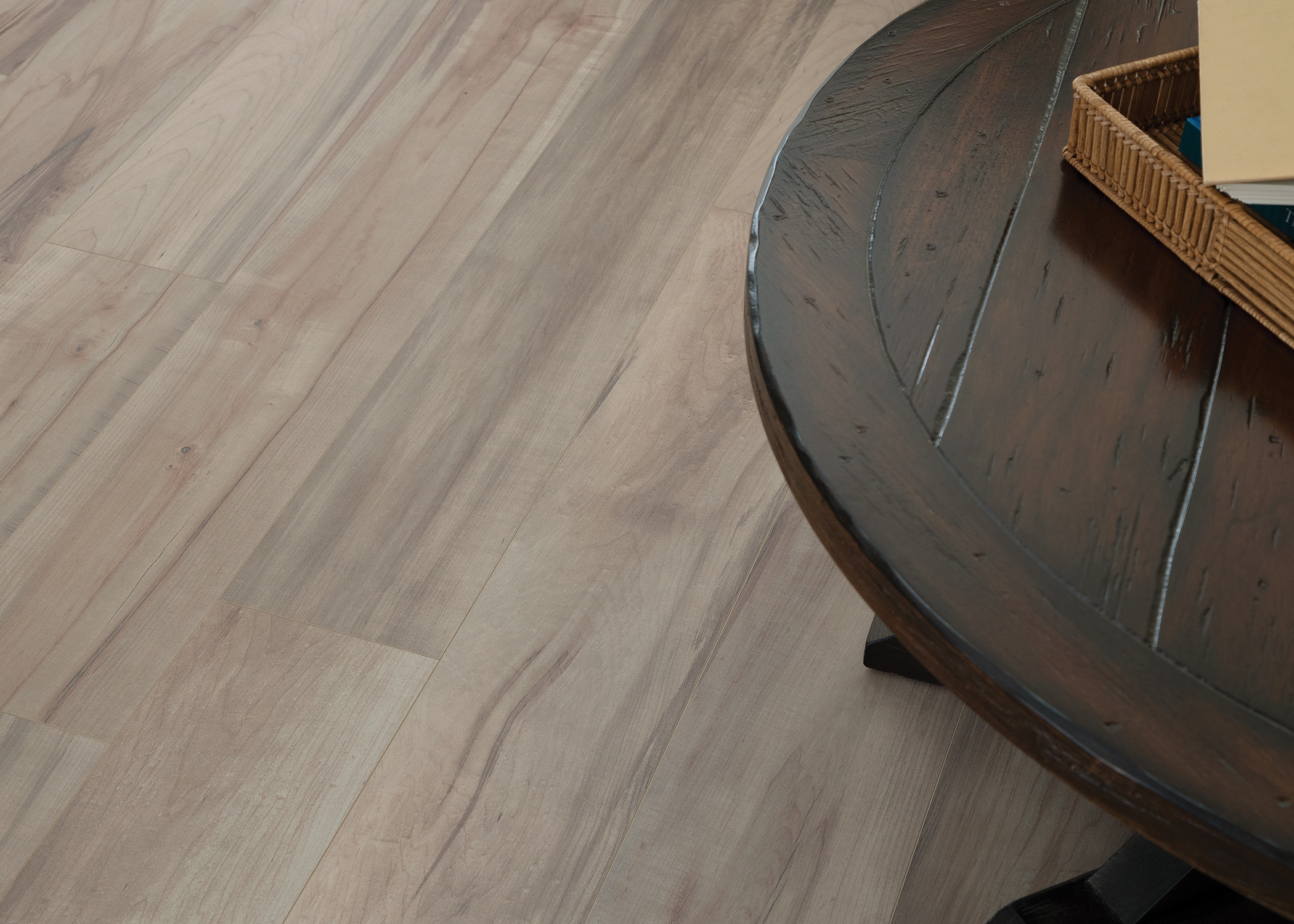 7mm+Pad Preston Peak Marble Hybrid Resilient Flooring closeup of floor in living room with dark brown coffee table