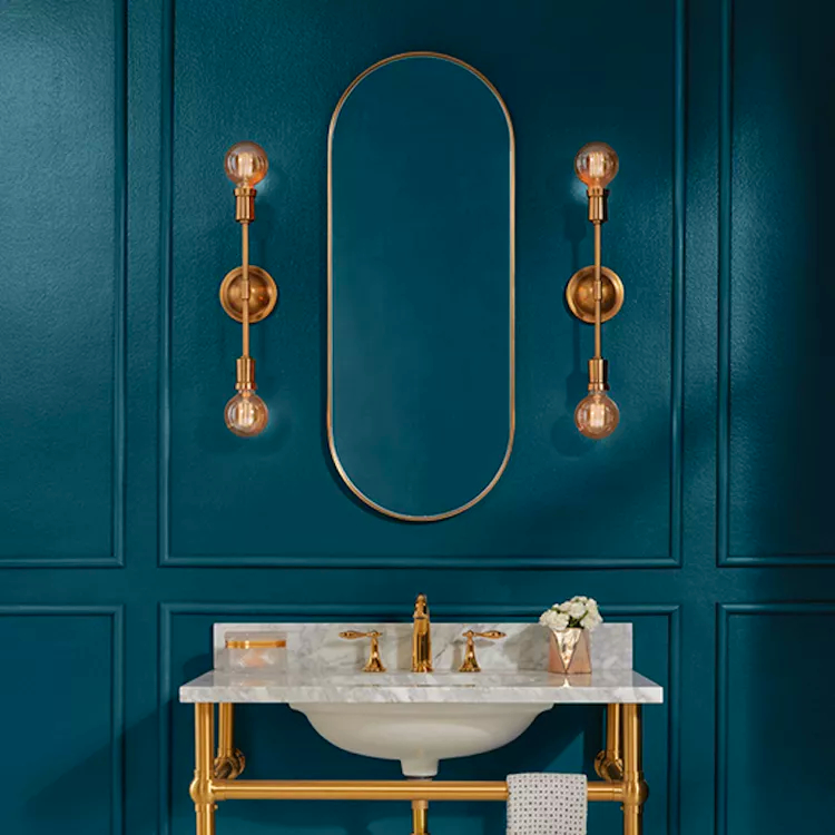 bathroom vanity sink in front of blue green wall