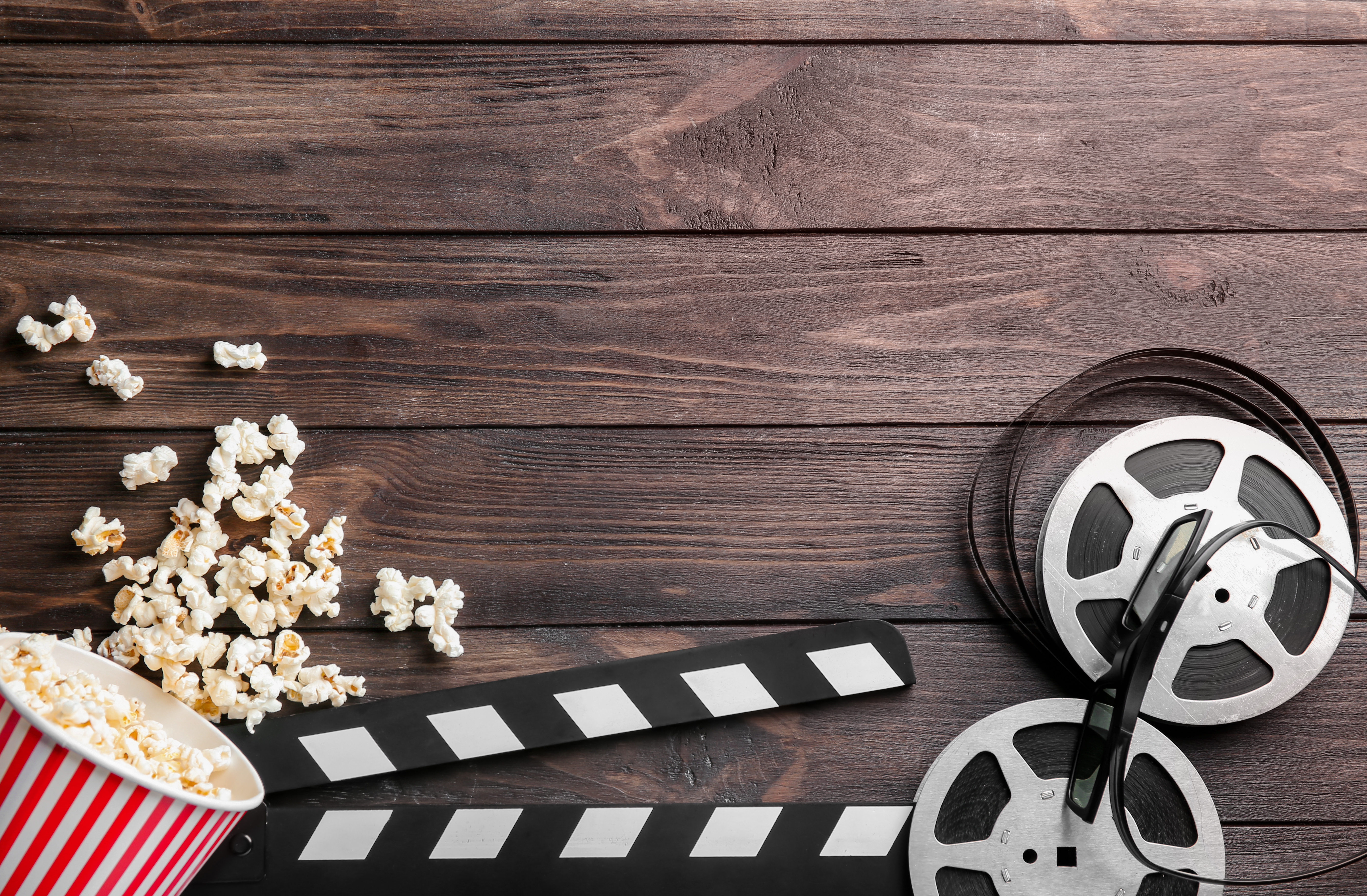 image of popcorn and filmmaking item against wood planks 