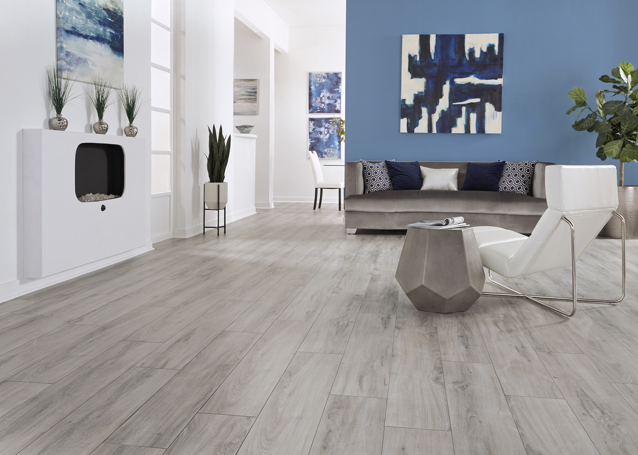 Modern living room with gray wood look laminate flooring from LL Flooring