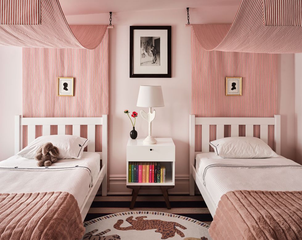 children's room with theme of animals and pink and two twin beds