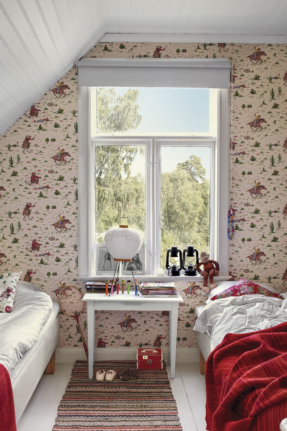 Children's bedroom with two twin beds and decorative wallpaper