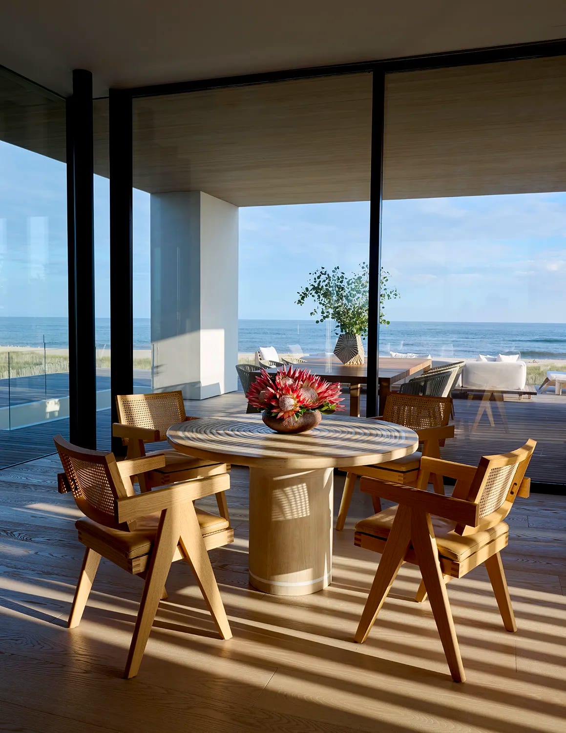 a dining room near large windows near ocean