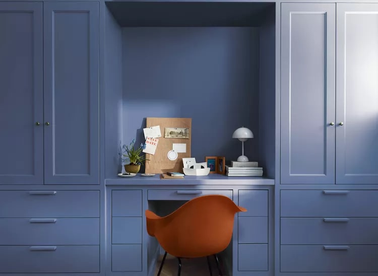 blue cabinets and a chair