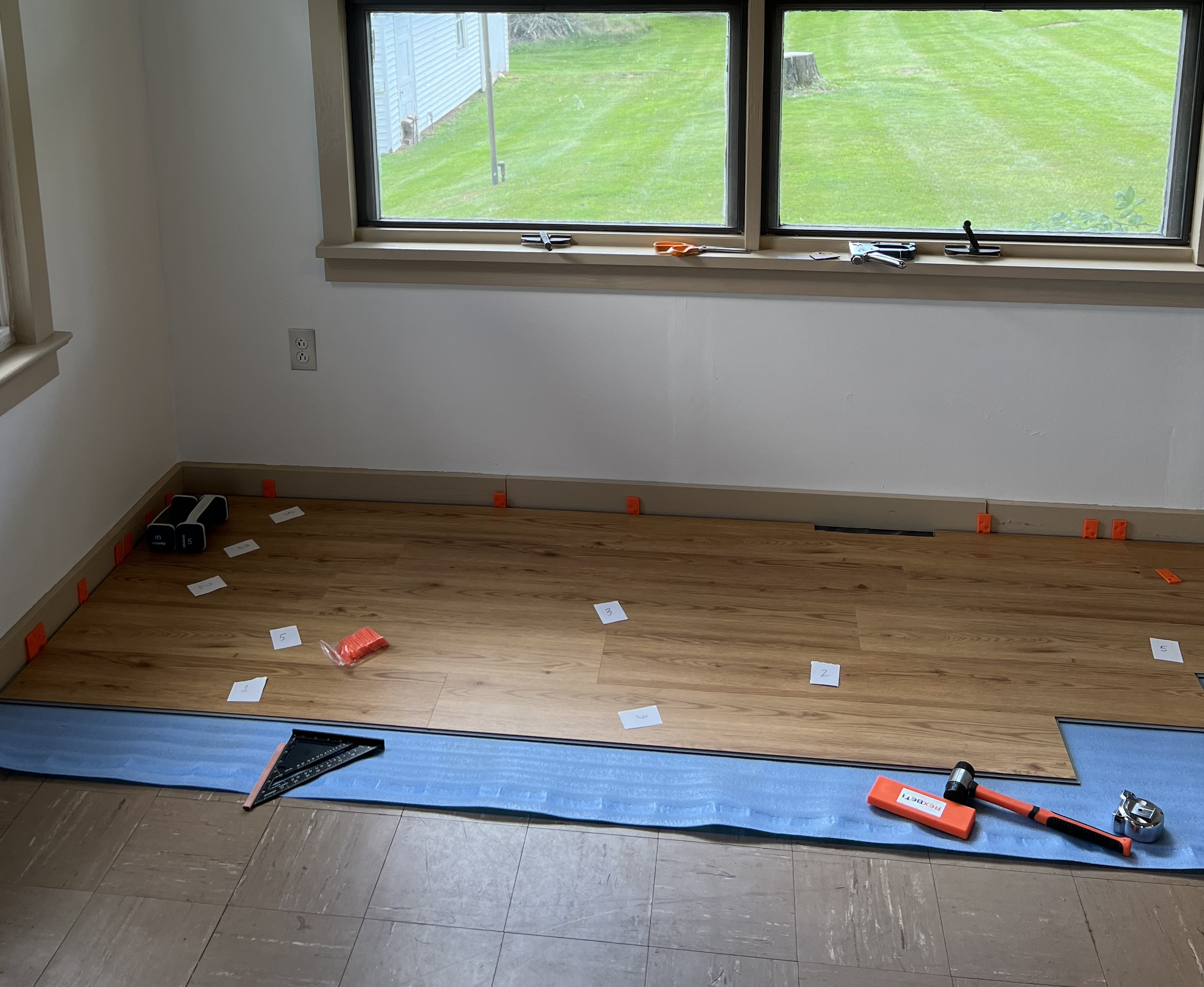 mid installation process of rigid vinyl plank flooring