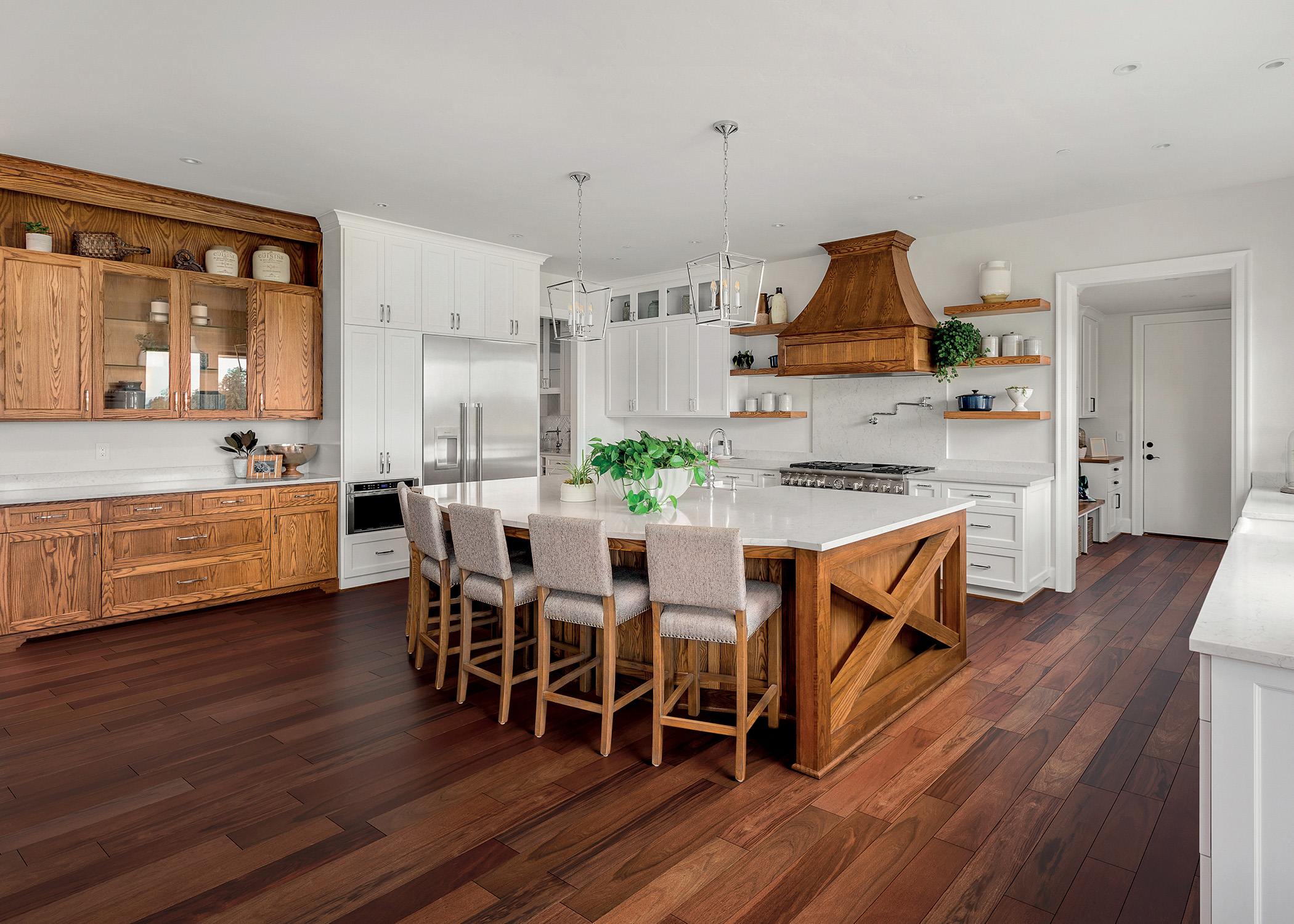 dark brown engineered hardwood floor in farmhouse style kitchen with white cabinets and rustic wood island