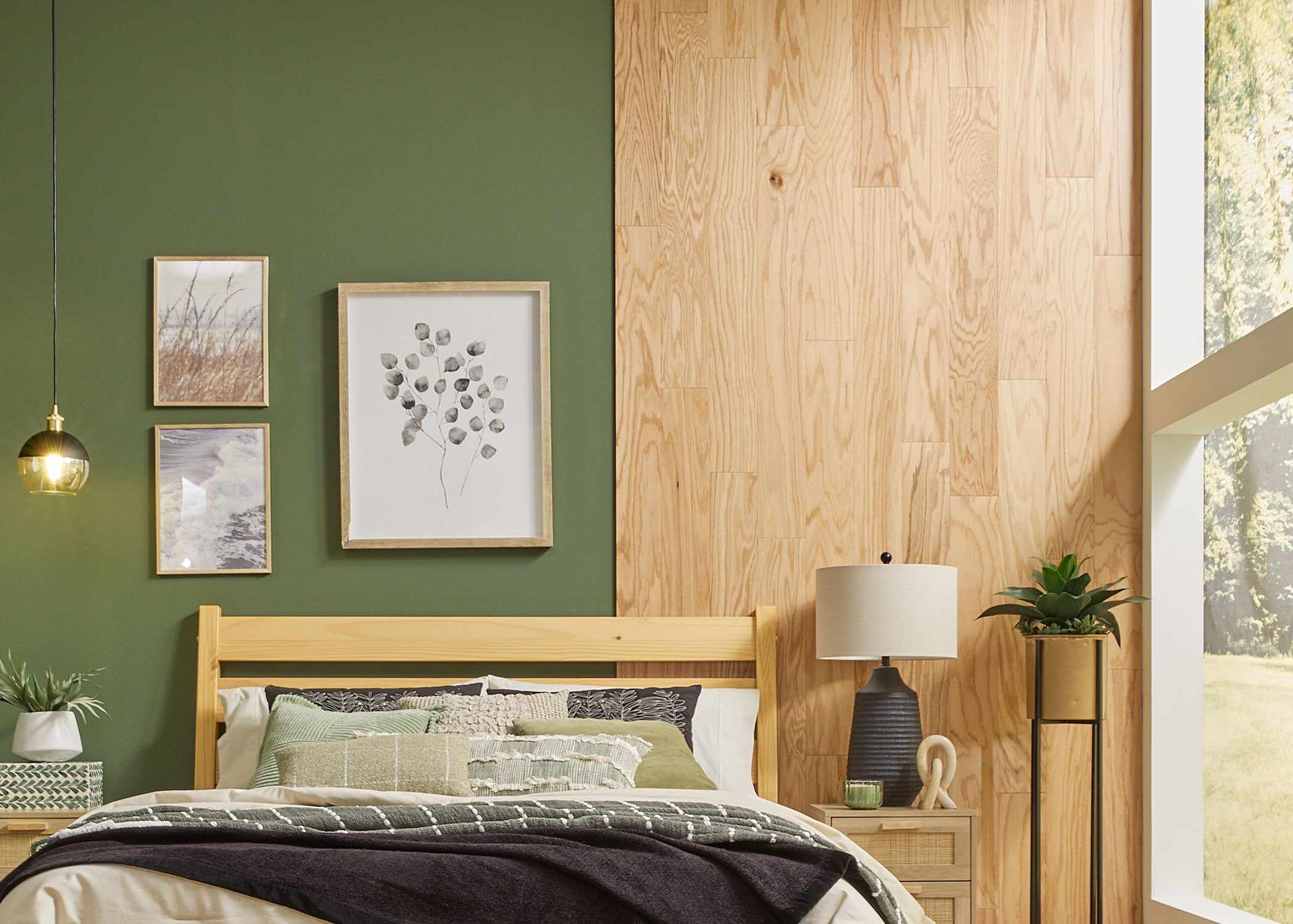 red oak solid hardwood floor installed as accent wall in bedroom with green accent wall and blonde wood furnishings