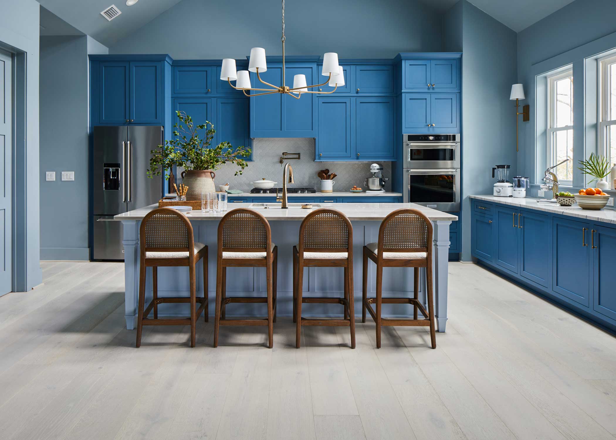 whitewashed engineered hardwood floor in HGTV Dream Home 2024 kitchen with blue cabinets and white countertops