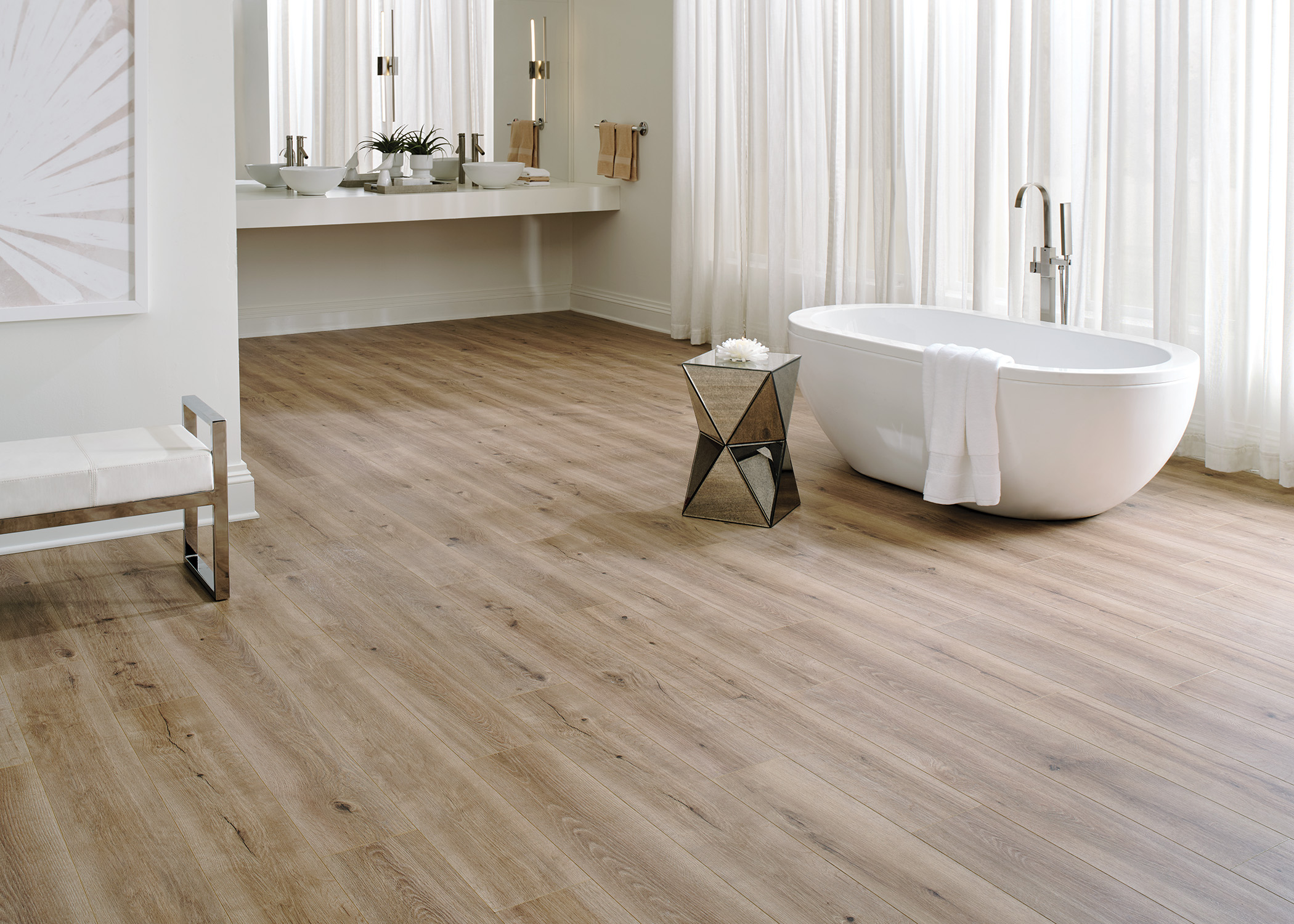 light brown waterproof hybrid resilient floor in bathroom with oval freestanding bathtub and floating vanity