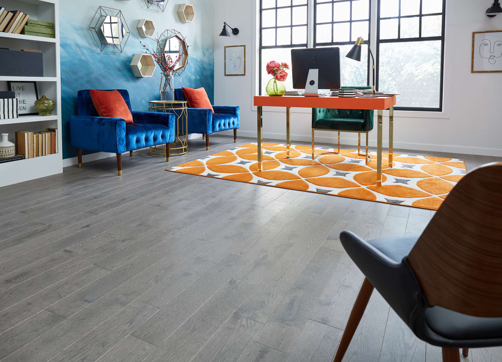 3/4 in. x 5.25 in. Vineyard Haven Oak Distressed Solid Hardwood Flooring in. office with orange desk and bright blue accent chairs plus orange and gray area rug