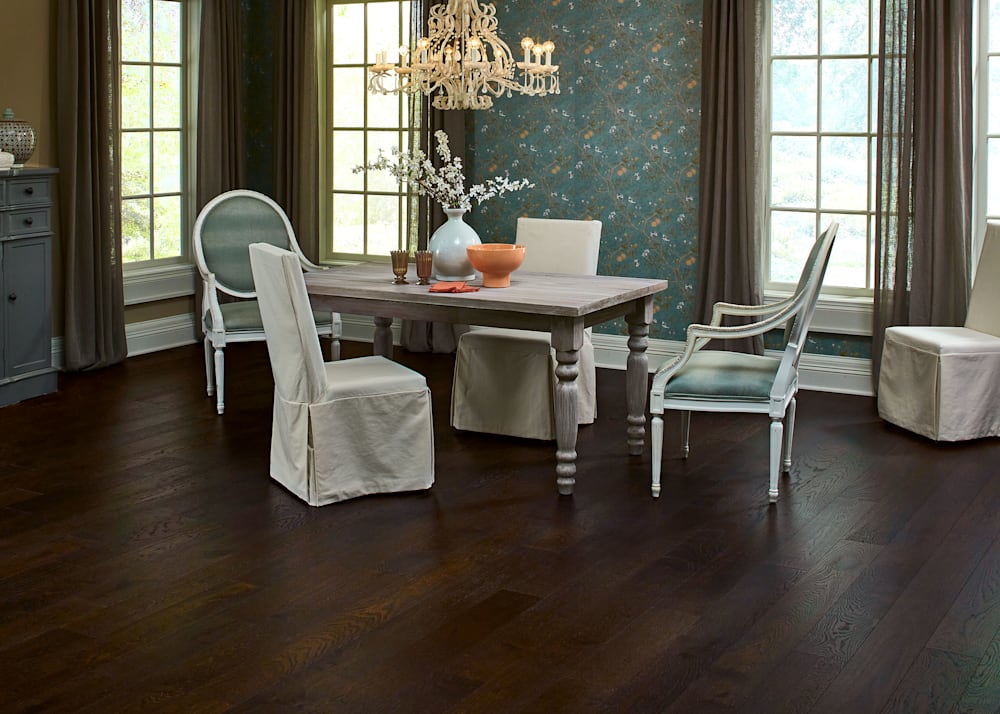 3/8 in. x 6-3/8 in. Palisade Oak Wire Brushed Engineered Hardwood Flooring in dining room with bleached wood dining table and chairs with green velvet cushions plus green floral wallpaper and taupe sheers plus off white chandelier