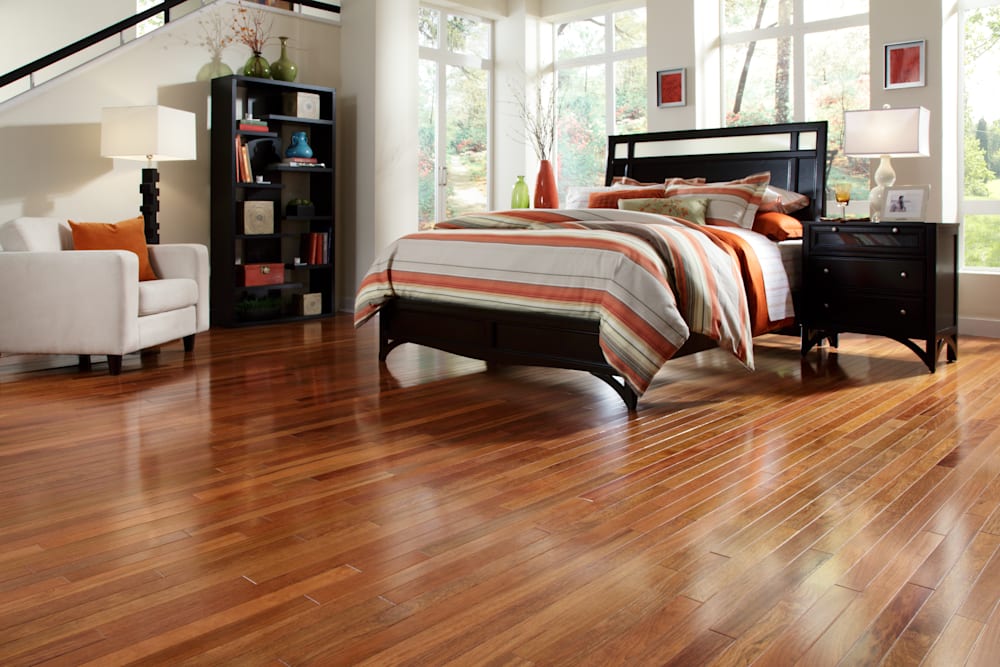 3/4 in. Select Brazilian Cherry Solid Hardwood Flooring 2.25 in. Wide in bedroom with dark brown furniture and orange stripped bedding