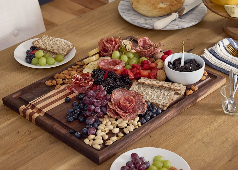 Stoverstown 1 in x 15 in x 20 in Butcher Block Cutting Board on dining table with various meats cheeses and fruits