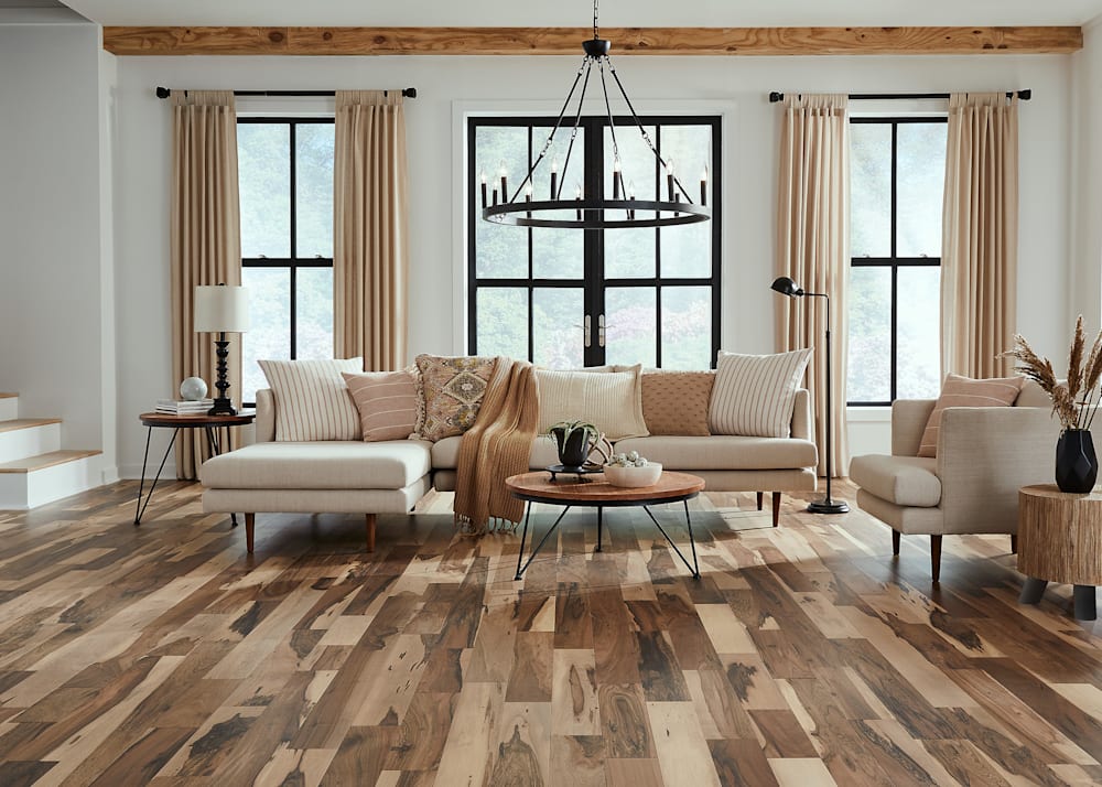 1/2" x 5in Matte Brazilian Pecan Engineered Hardwood Flooring in living room with cream colored sectional and arm chair plus beige pillows and throw
