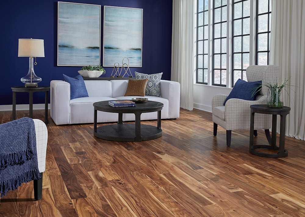 7/16" x 4.72" Tobacco Road Acacia Engineered Hardwood Flooring in living room with white sofa and royal blue walls
