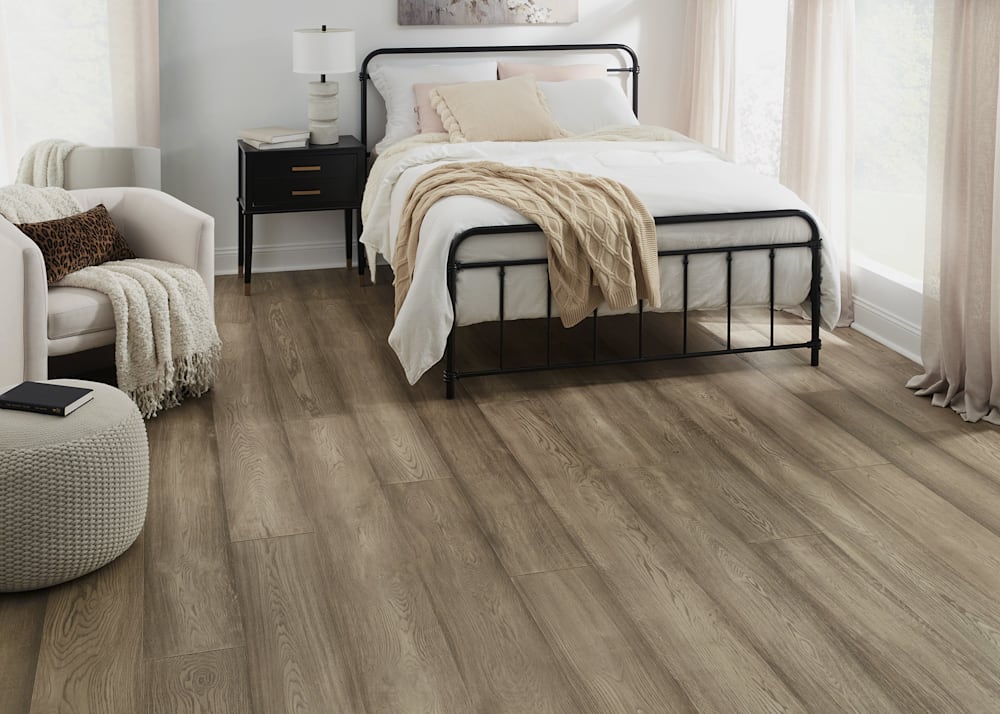 5/8 in x 9.5 in Tortuga Beach White Oak Distressed Engineered Hardwood Flooring in bedroom with black wrought iron bed and b