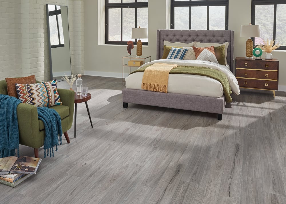 5mm+Pad Bavarian White Oak Rigid Vinyl Plank Flooring in bedroom with gray fabric headboard and army green accent chair