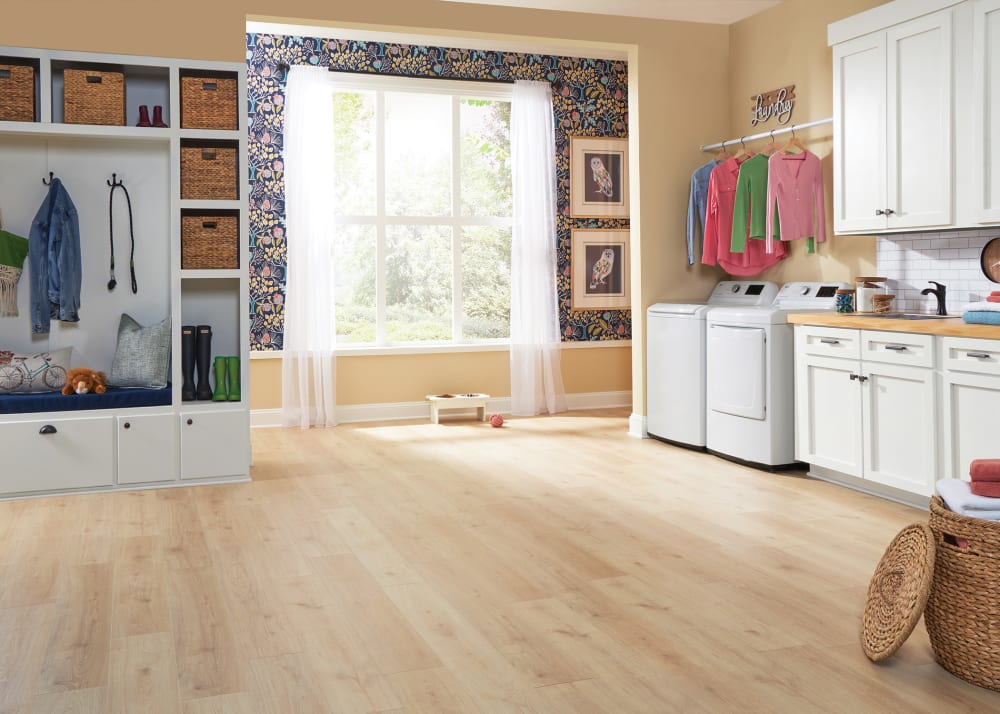 7mm+Pad Magnolia Bridge Oak Hybrid Resilient Flooring in laundry room with white built in storage