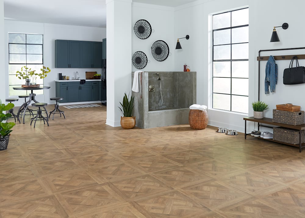 8mm Dapper Parquet Waterproof Laminate Flooring in mudroom with dog washing station leading into kitchen with dark gray cabinets plus tall dining table with four stools