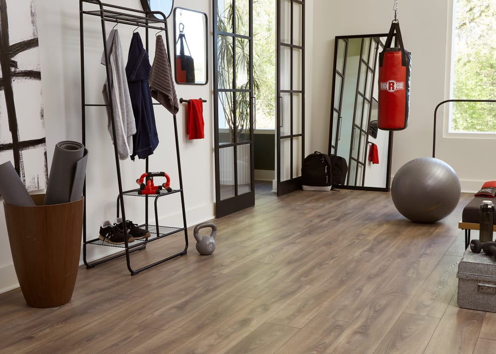 12mm+Pad Almond Crate Oak Waterproof Laminate Flooring in home gym with sliding glass doors