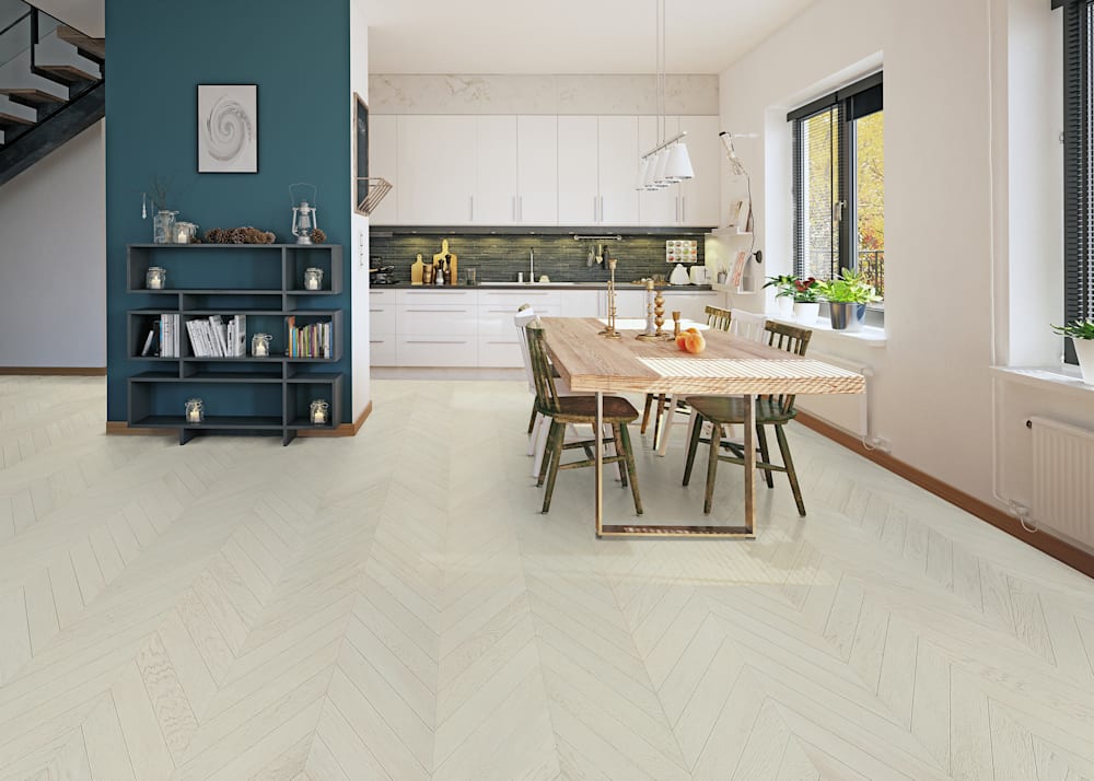 5/8 in x 11.42 in Chelsea Chevron Engineered Hardwood Flooring in open dining room and kitchen with white cabinets plus light blonde wood table with rustic wood chairs