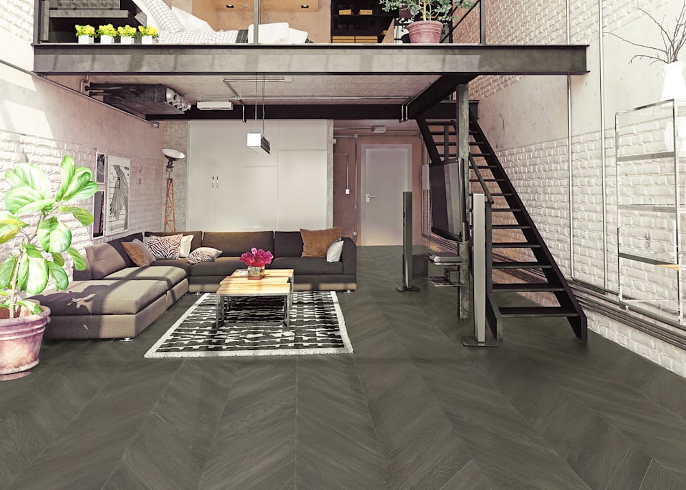 5/8 in x 11.5 in West Village Chevron Engineered Hardwood Flooring in loft with dark brown sectional sofa and bedroom with yellow flowers above in loft with metal stairs