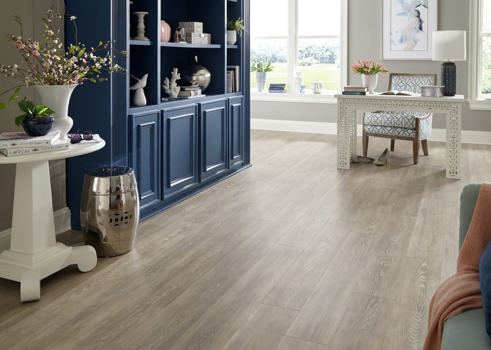 12mm Capistrano Beach Oak Waterproof Laminate Flooring in office with blue bookcase and white desk