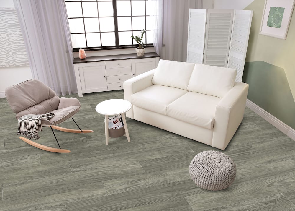 8mm with pad Wintertide Oak Rigid Vinyl Plank Flooring in living room with white upholstered loveseat pus taupe upholstered rocker and light gray pouf plus light and dark green accent wall