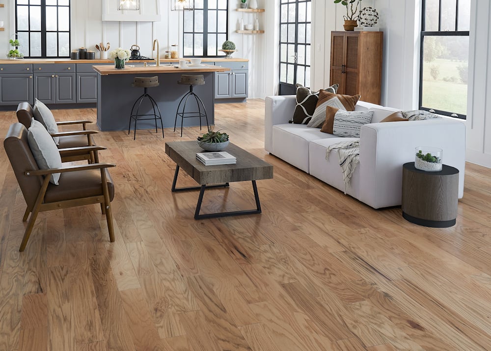 3/8" x 5 in. Natural Red Oak Engineered Hardwood Flooring in open concept living room and kitchen with oatmeal upholstered sofa plus dark brown leather and wood accent chairs and gray kitchen cabinets with island and wood and metal stools