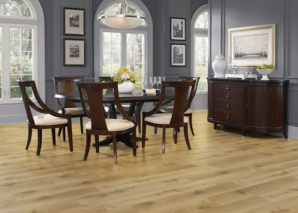 5mm with Pad Woodley Oak Waterproof Rigid Vinyl Plank Flooring in dining room with dark brown dining table and chairs with cream upholstered seats and dark brown wood buffet plus dark gray walls