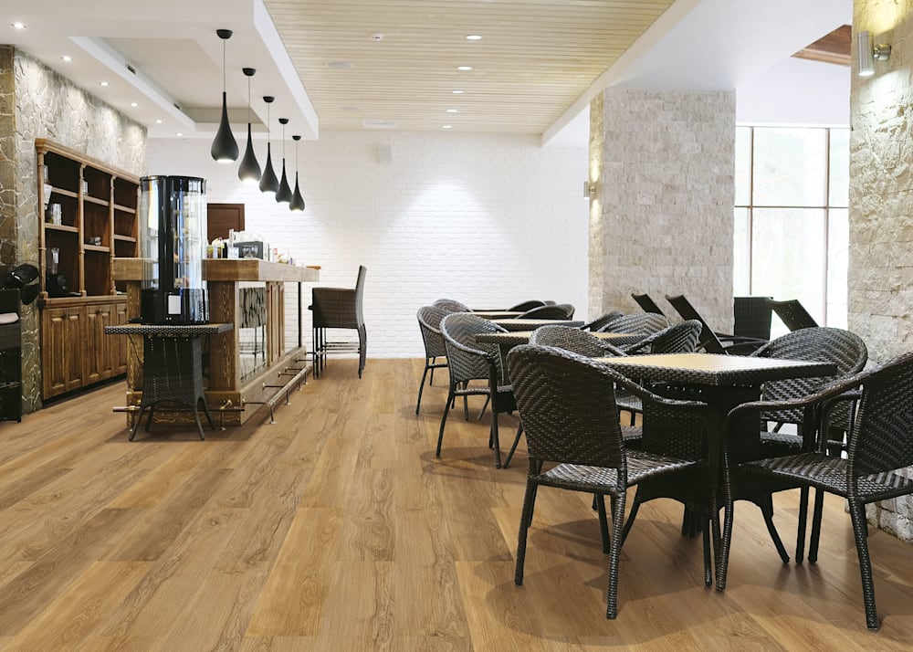 6mm x 7.67 in Heritage Oak Waterproof Cork Flooring in restaurant dining room with black dining chairs and bistro tables plus bar area