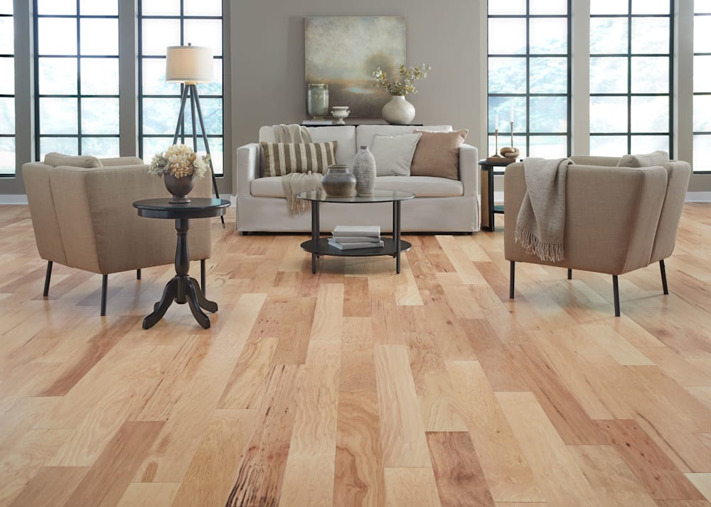 3/8 in x 5-3/8 in Sun Valley Hickory Engineered Hardwood Flooring in living room with beige furnishings plus dark wood accent tables and beige walls