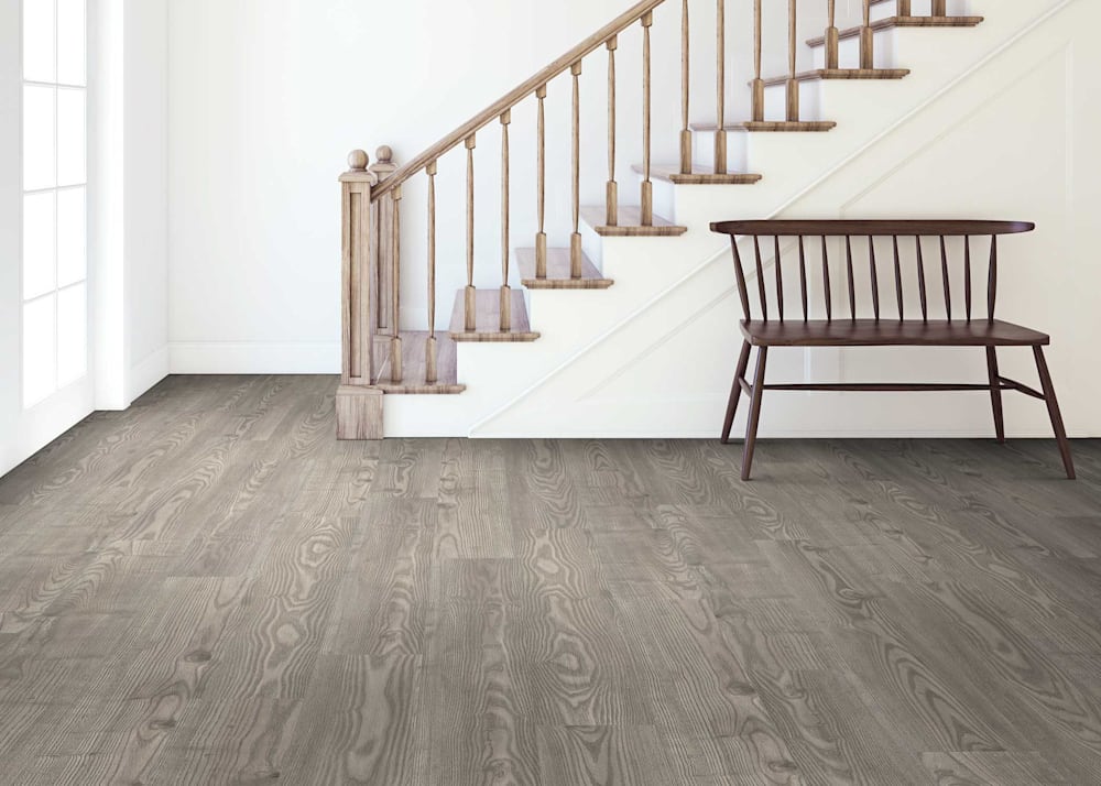 7mm with Pad Duskfall Ash Waterproof Rigid Vinyl Plank Flooring in entryway with dark wood bench and wood stairs