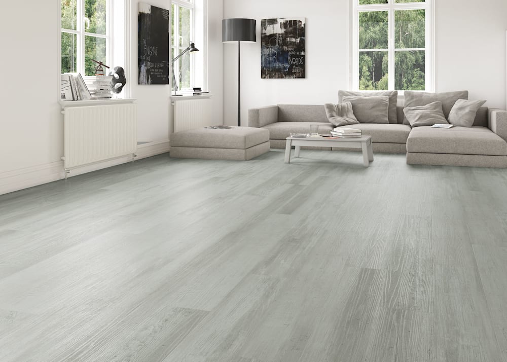 6mm with Pad New Pearl Cove Rigid Vinyl Plank Flooring in living room with beige sectional and black and white artwork