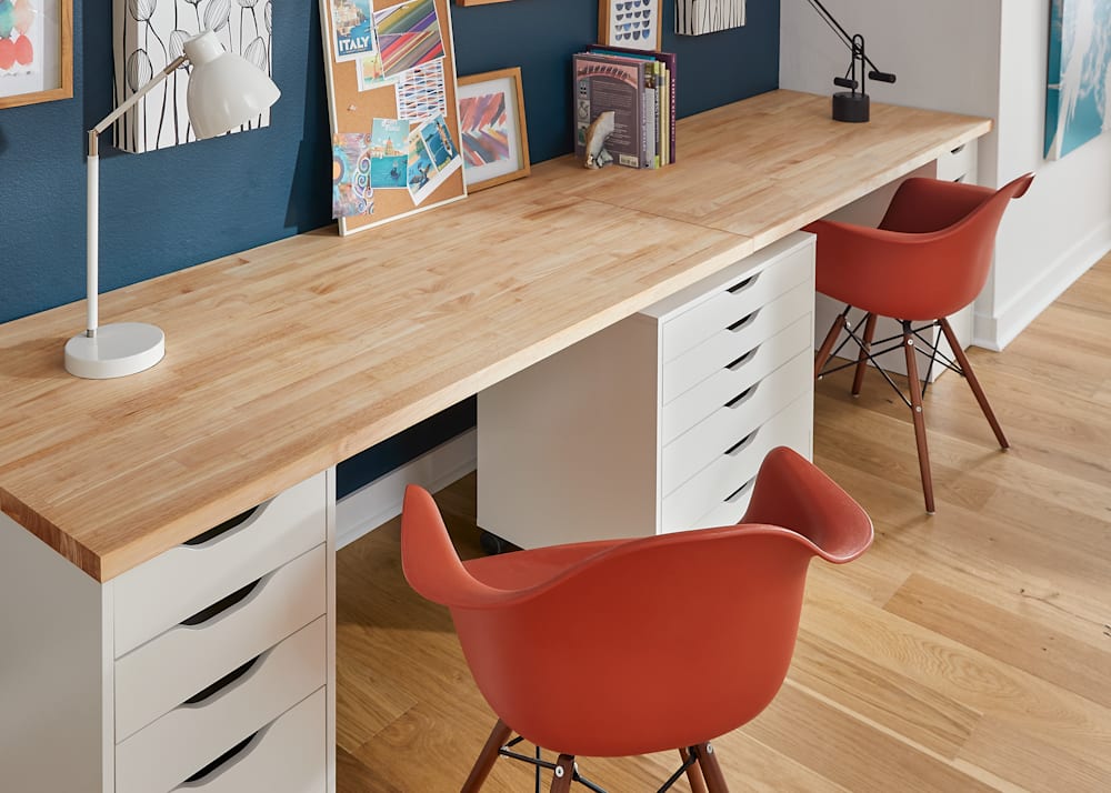30 in x 60 in Unfinished Essential Hevea Butcher Block Desktop in office with two desktops side by side to form large desk and orange desk chairs
