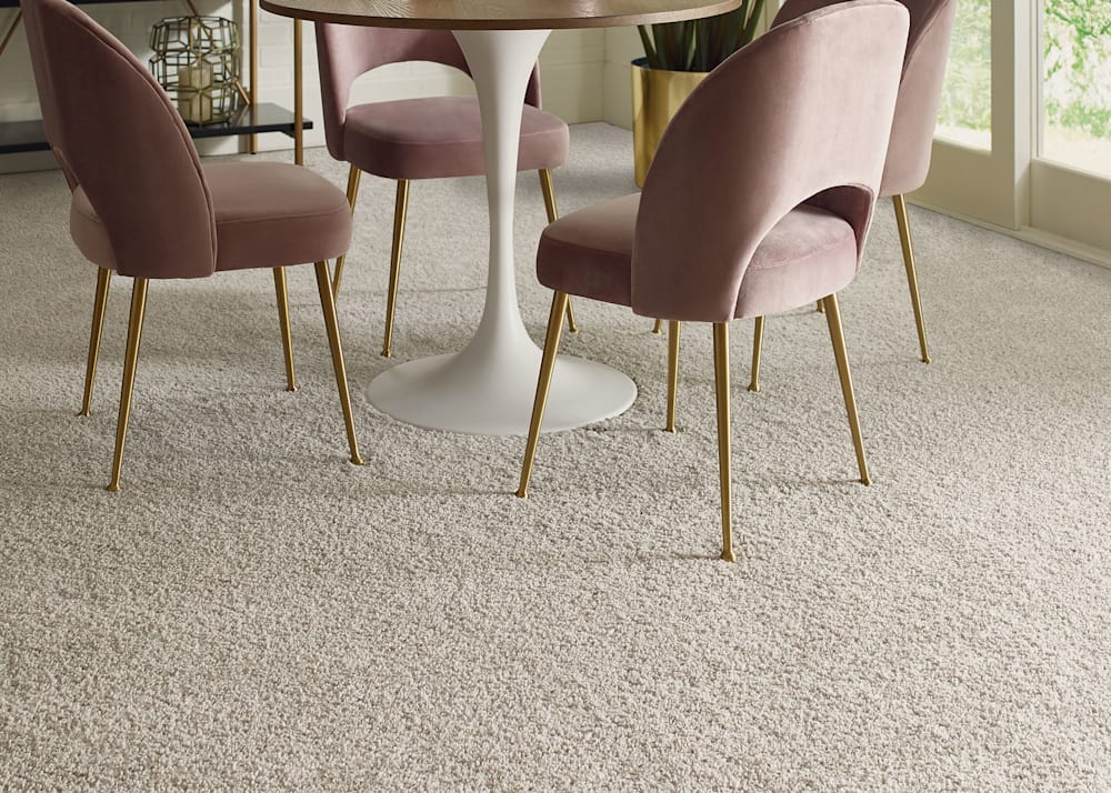 Mount Coulson Carpet in Fog in dining room with wood tulip table and blush velvet dining chairs with gold legs