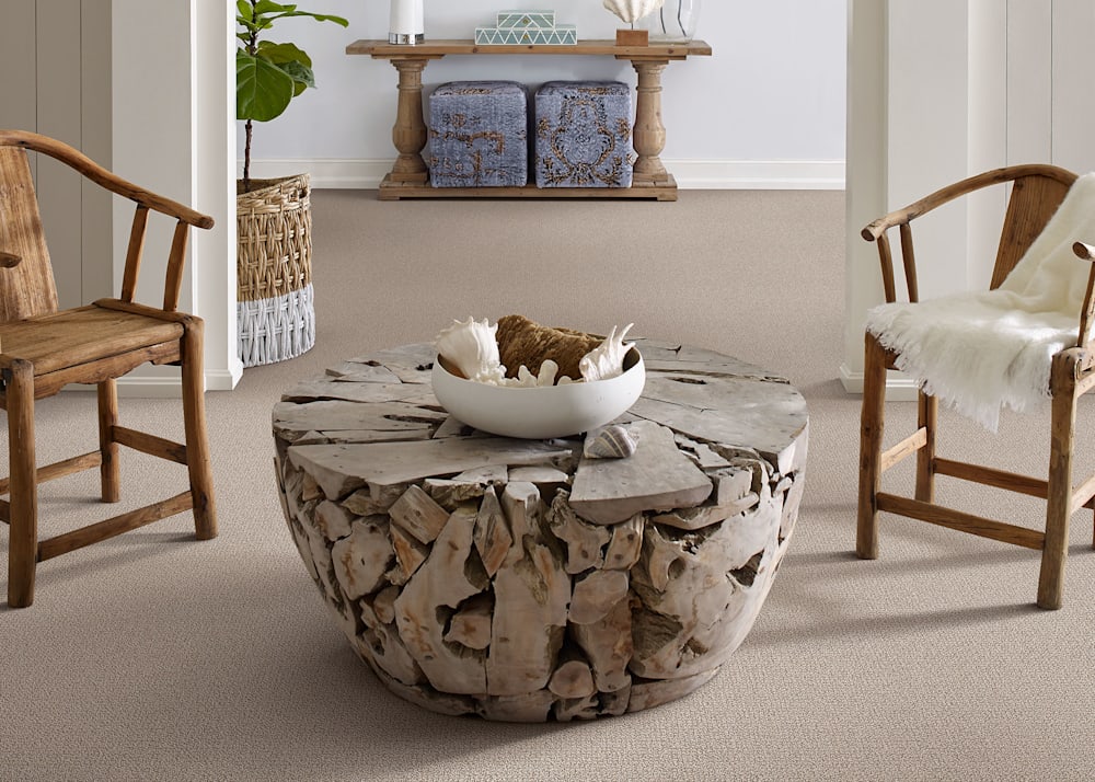 Palma Beach Carpet in Cityscape in living room with two rustic wood arm chairs and live edge bleached round coffee table