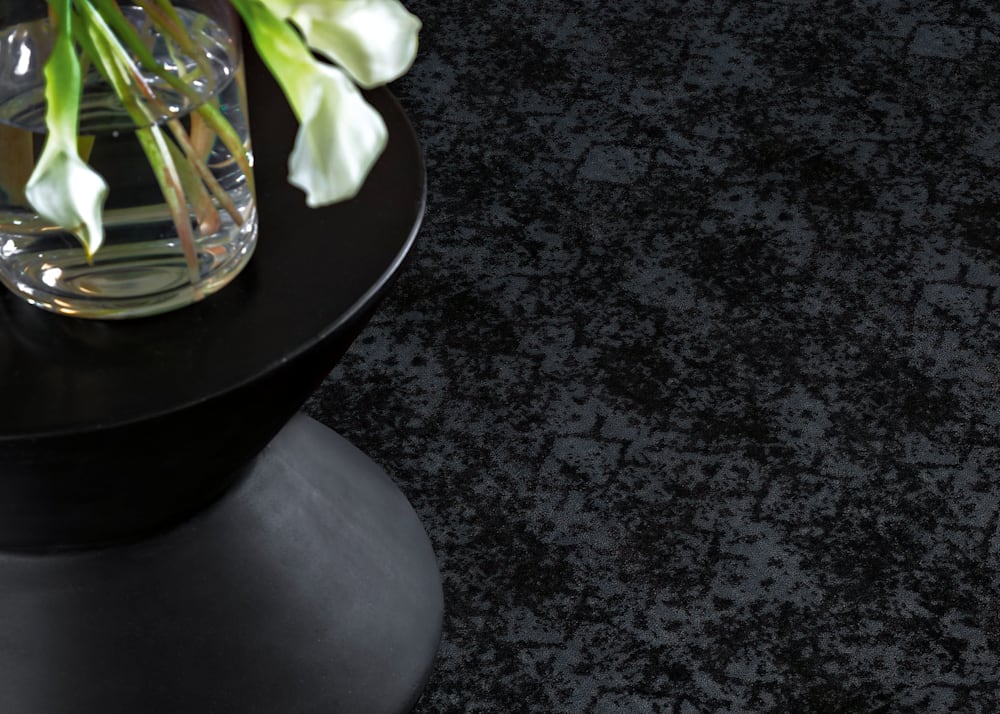 Floral Park Carpet in Abyss in living room with black side table and white flowers in a vase